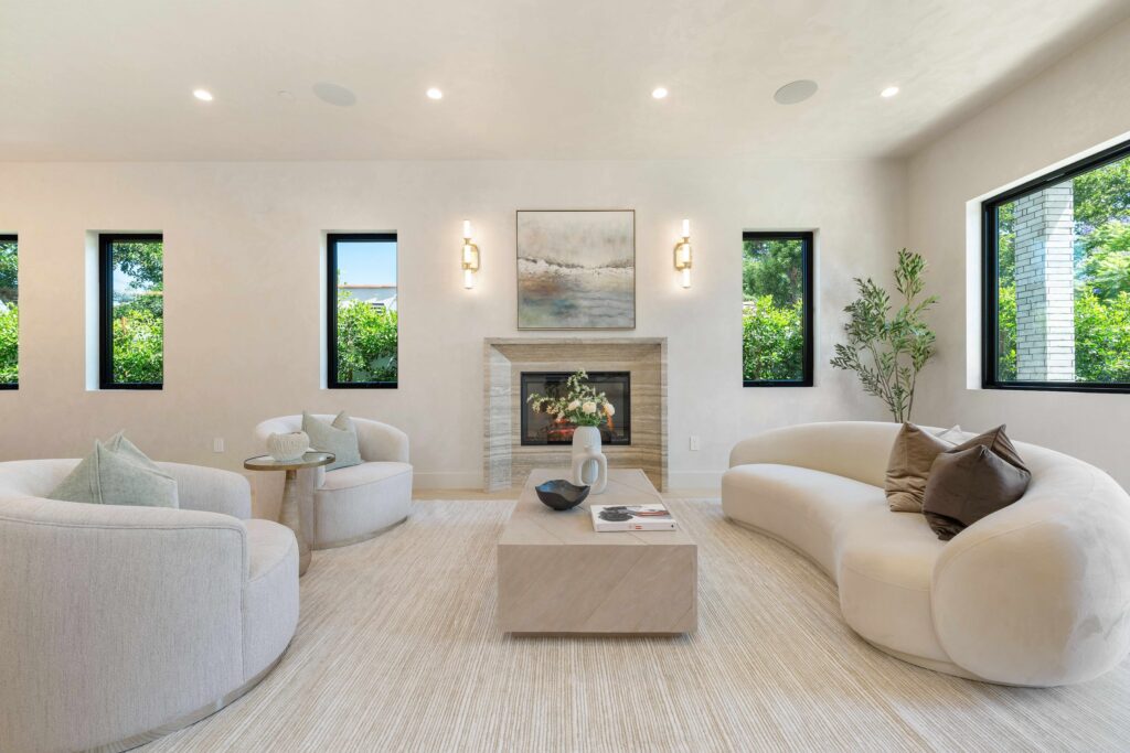 Staging team arranging furniture with measured spacing and balanced design in vacant home