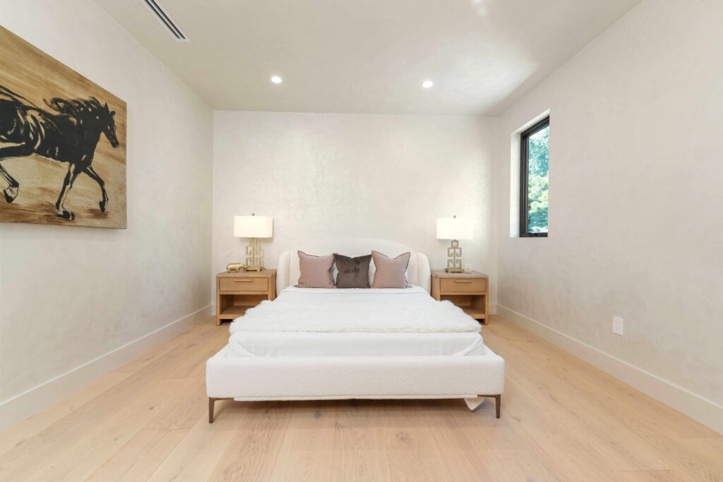 Professional home stager arranging furniture and decor for buyer-focused layout