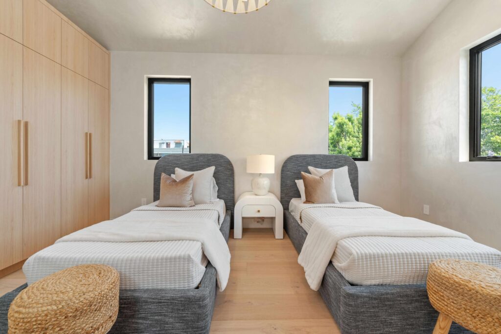 Experienced home stager adjusting decor and furniture balance in bright Glendale listing
